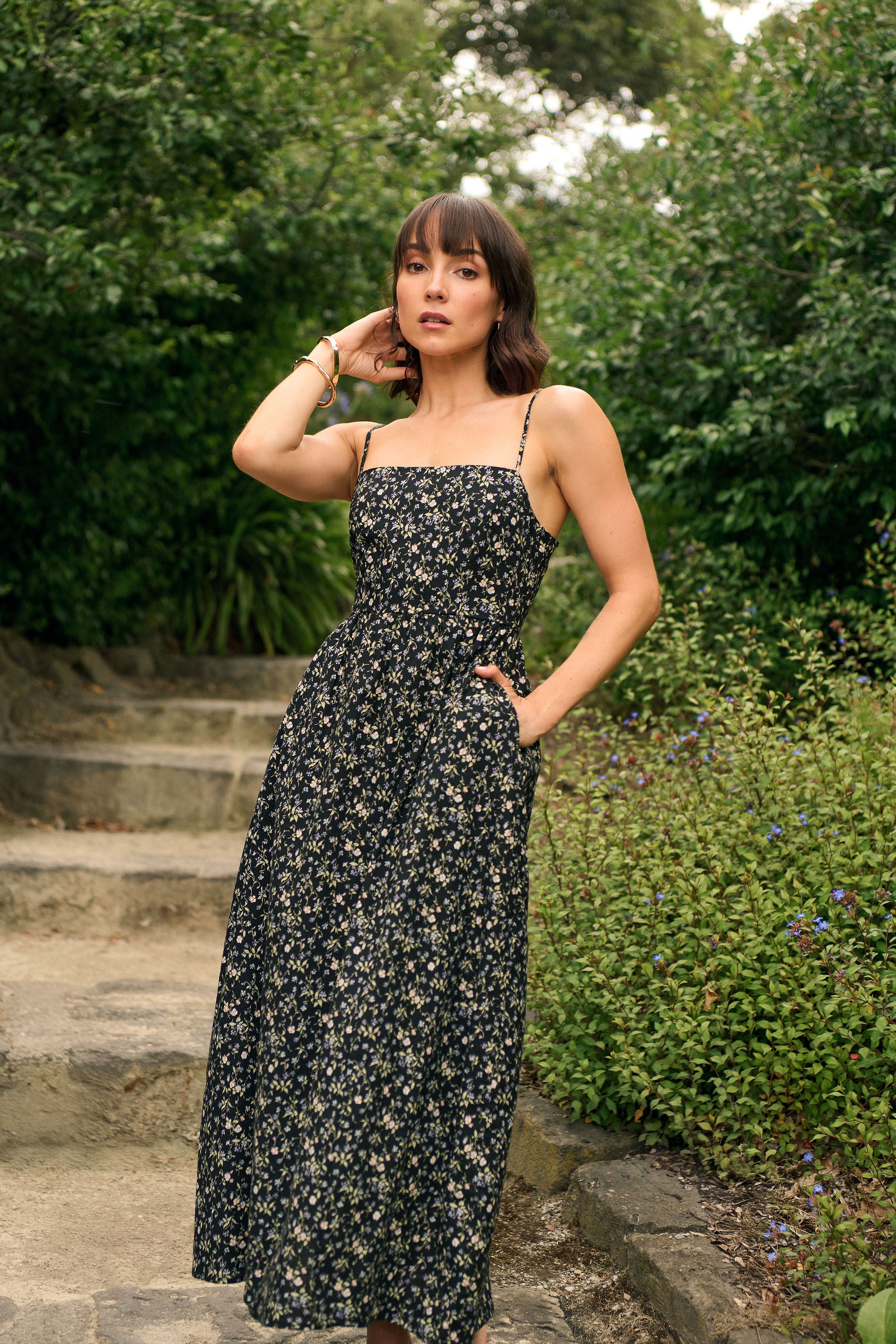 Woman wearing a peite maxi dress with a floral pattern made from 100% Japanese Cotton